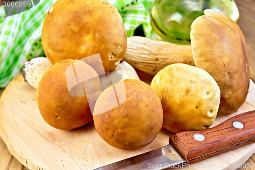 Image of Ceps with knife and napkin on board