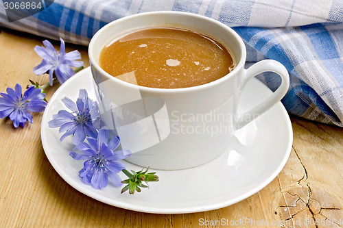Image of Chicory drink in white cup with napkin on board