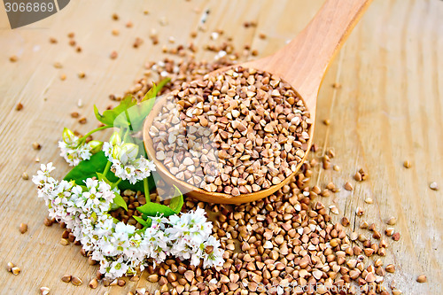 Image of Buckwheat in spoon on board with flower