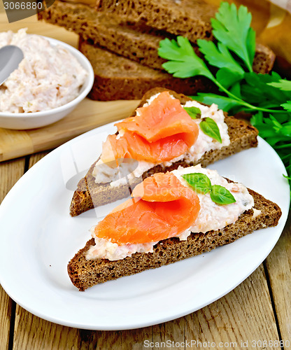 Image of Sandwiches on pieces of bread with salmon and cream