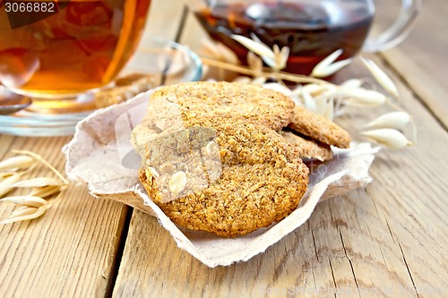 Image of Cookies oatmeal with spikelet and tea on board