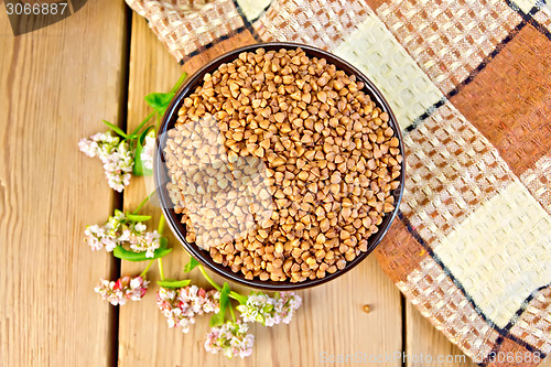 Image of Buckwheat in bowl with flower on board top