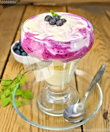 Image of Dessert milk with blueberries in glassware on board