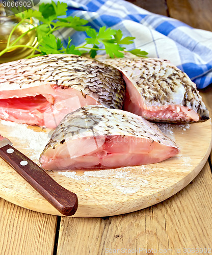 Image of Bream crude pieces with knife on board