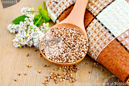 Image of Buckwheat in wooden spoon with flower and doily