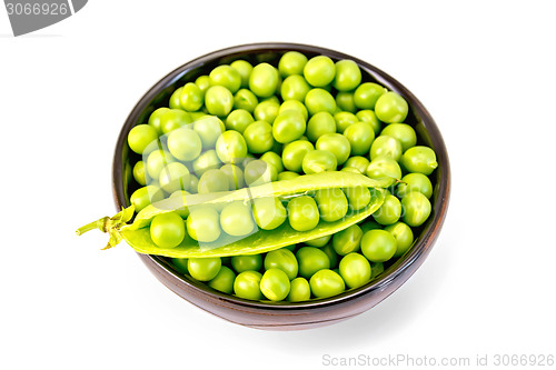 Image of Green peas in brown bowl with pod