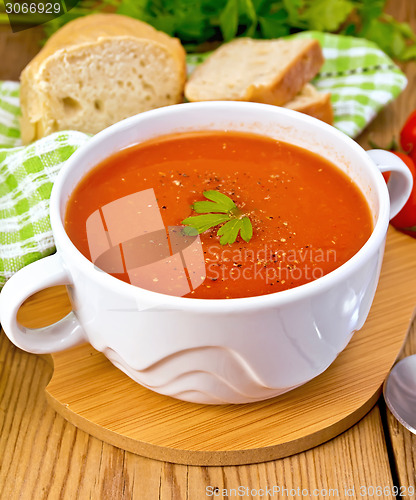 Image of Soup tomato with pepper in bowl on board