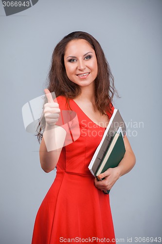 Image of Young attractive girl in red with folders