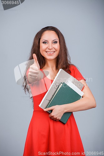 Image of Young attractive girl in red with folders