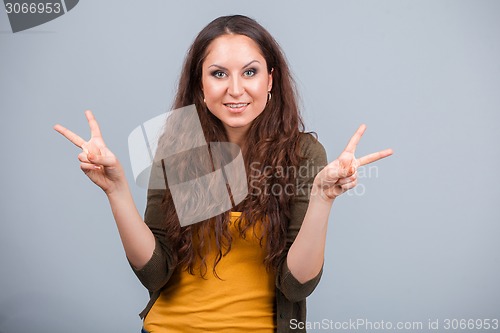 Image of Woman shows symbol of victory