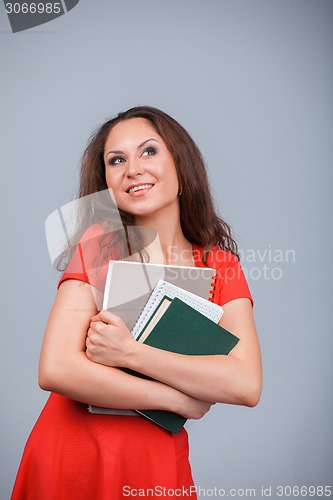 Image of Young attractive girl in red with folders