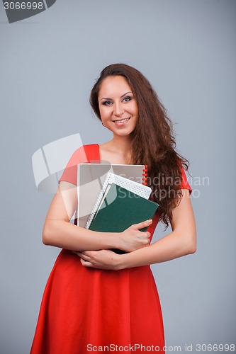 Image of Young attractive girl in red with folders