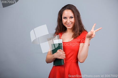 Image of Young attractive girl in red with folders