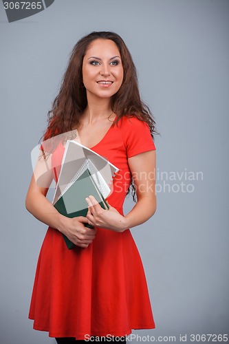 Image of Young attractive girl in red with folders