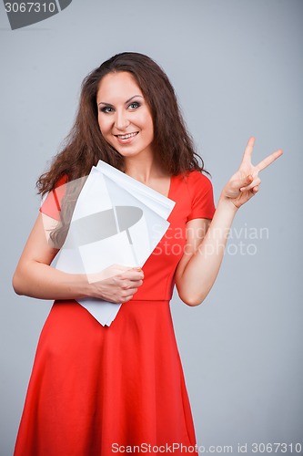 Image of Young attractive girl in red with folders