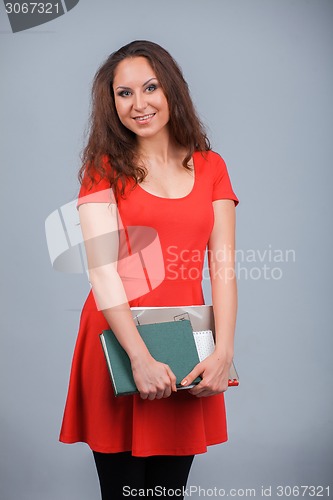 Image of Young attractive girl in red with folders