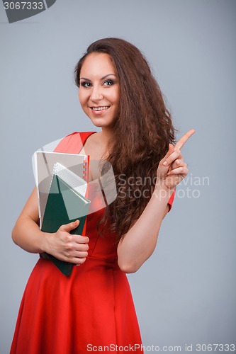 Image of Young attractive girl in red with folders