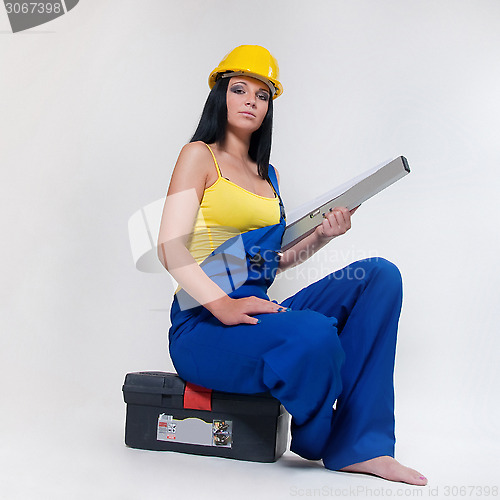 Image of working girl in yellow helmet