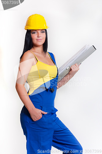 Image of working girl in yellow helmet