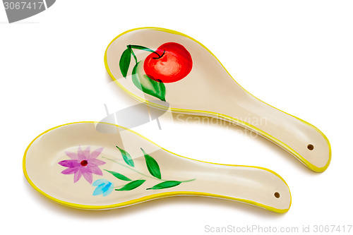 Image of Two large ceramic spoon on a white background.