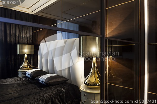 Image of Interior bedroom bed and table lamps
