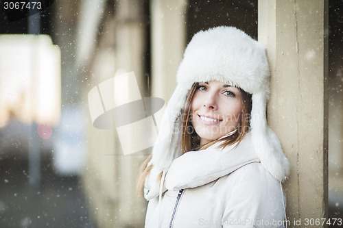 Image of Smiling young woman in blizzard