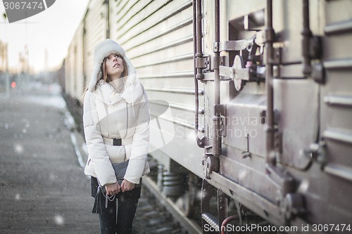 Image of Stylish woman in snowy day on a platform