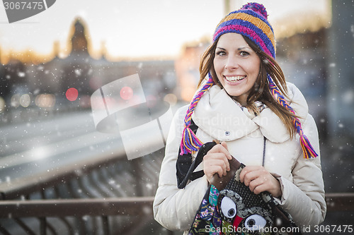 Image of Winter woman with colorfull hat in city