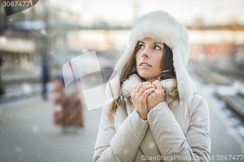 Image of Young woman feeling cold in winter day