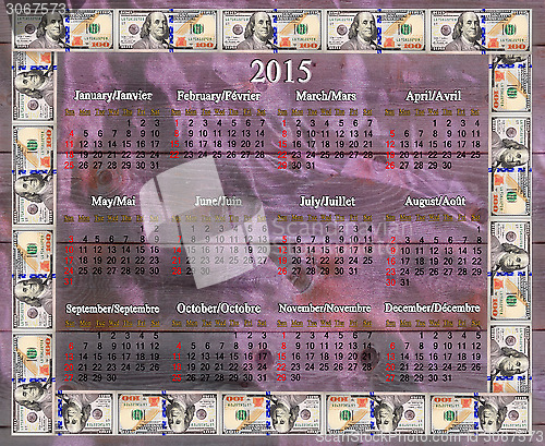 Image of calendar for 2015 in dollars' frame on lilac