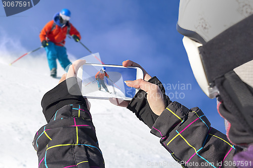 Image of Photographed skiers with cell phone