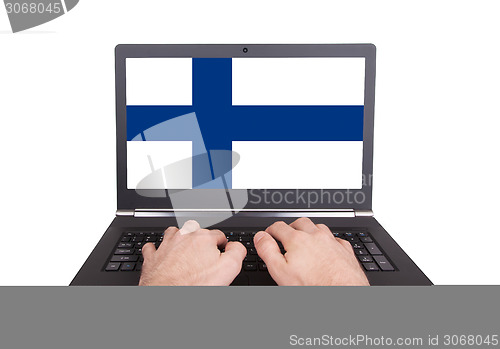 Image of Hands working on laptop, Finland