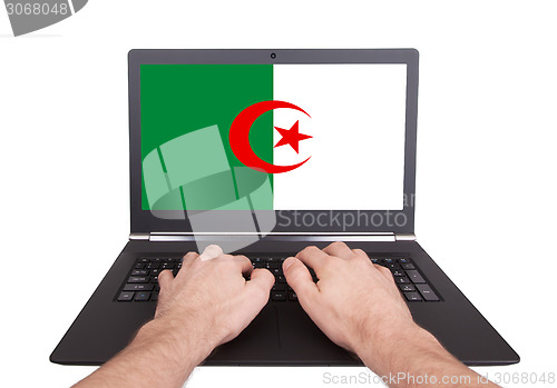 Image of Hands working on laptop, Algeria