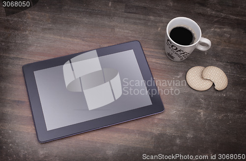 Image of Tablet touch computer gadget on wooden table