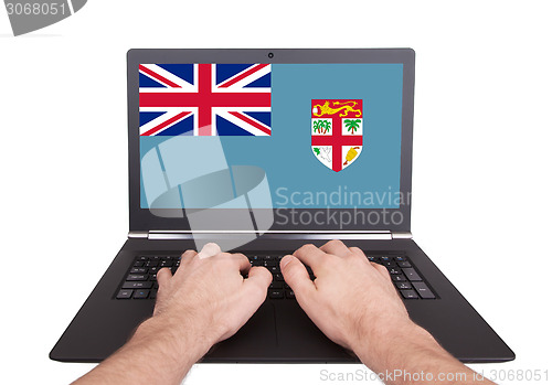 Image of Hands working on laptop, Fiji