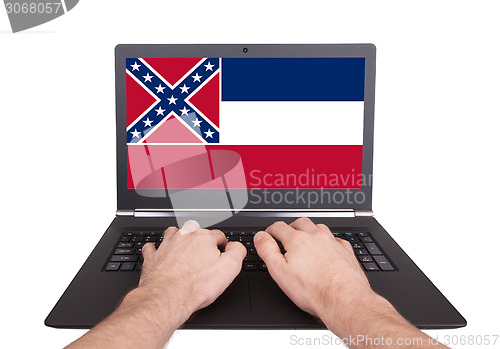 Image of Hands working on laptop, Mississippi
