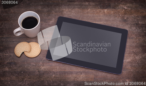 Image of Tablet touch computer gadget on wooden table