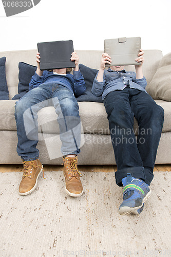 Image of Boys playing games on a Tablet