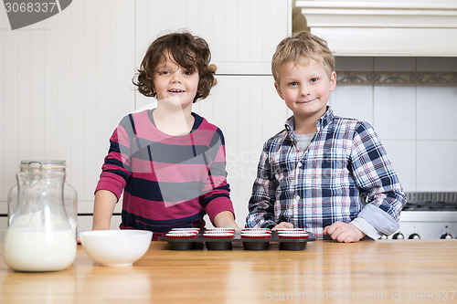 Image of Smiling children Preparing Cupcake In Kitchen