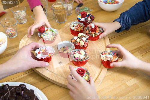 Image of Kids Picking Cupcakes At Table