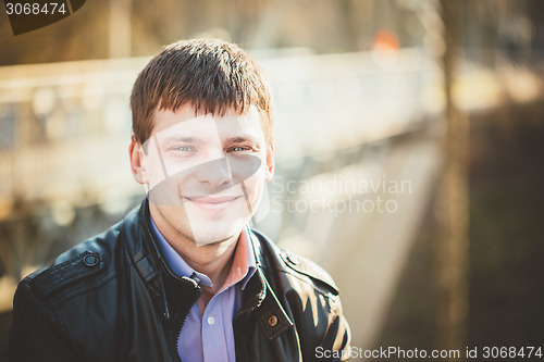 Image of Handsome man outdoors portrait. Autumn colors.