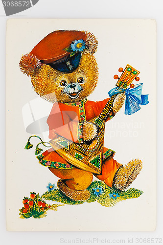 Image of Reproduction of antique postcard shows bear dressed in tradition