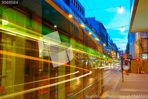 Image of Tram departs from a stop on street Aleksanterinkatu in Helsinki