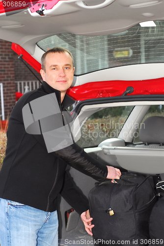 Image of Man car luggage