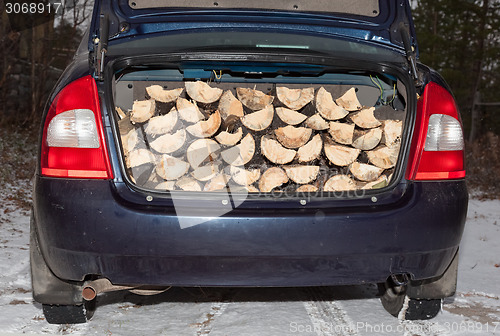 Image of car carries firewood in the trunk