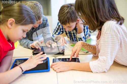 Image of group of school kids with tablet pc in classroom