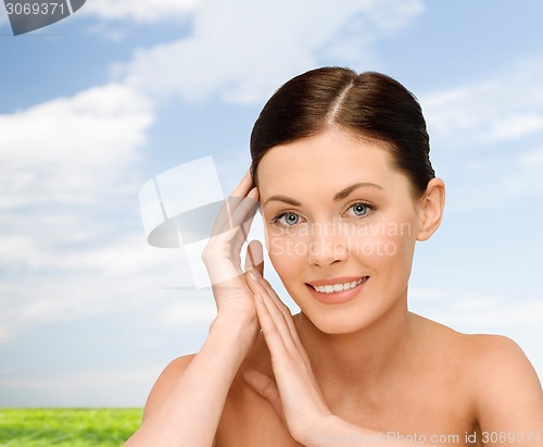 Image of smiling young woman with bare shoulders