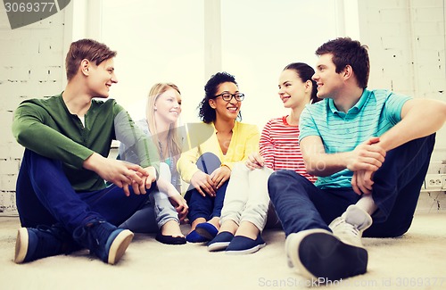 Image of five smiling teenagers having fun at home