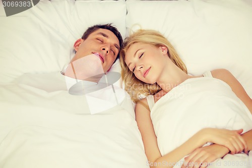 Image of happy couple sleeping in bed