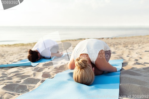 Image of close up of couple making yoga exercises outdoors